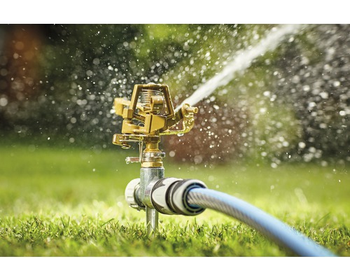 Tuinsproeier met waterslang in gebruik