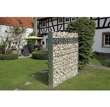 Gabionenwand in de tuin met huis op de achtergrond
