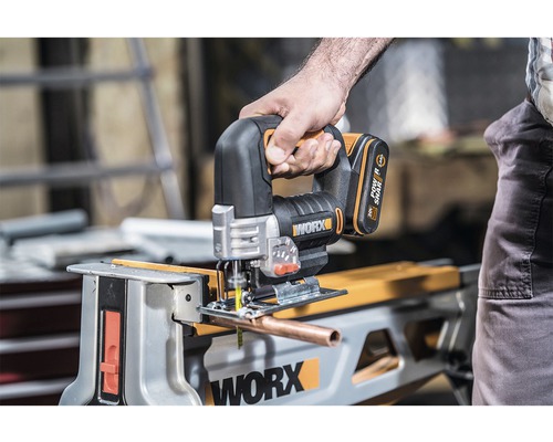 Accu decoupeerzaag in gebruik bij het zagen van een buis