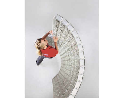 Vrouw monteert glazen bouwstenen in een ruimte