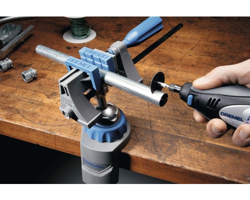Dremel Logo. Werkbank met Dremel Multi-bankschroef en Dremel Multitool die een pijp doorsnijdt.