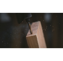 Dremel gereedschap boort in een stuk hout