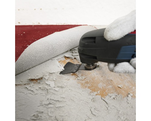 Oscillerende multitool die verf van een houten oppervlak verwijdert.