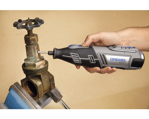 Dremel 8200 multifunctioneel gereedschap in gebruik op een metalen ventiel in een bankschroef