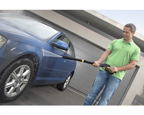 Man reinigt auto met hogedrukreiniger
