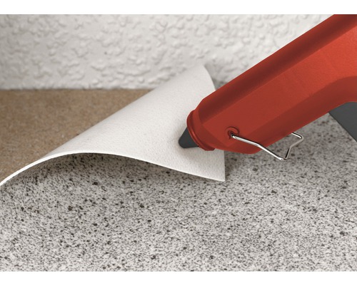 Lijmpistool bij het verlijmen van vloerbedekking