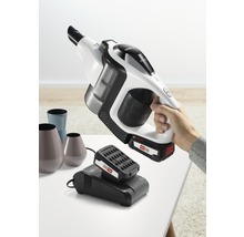 Accuzuiger met oplader en batterij op een tafel