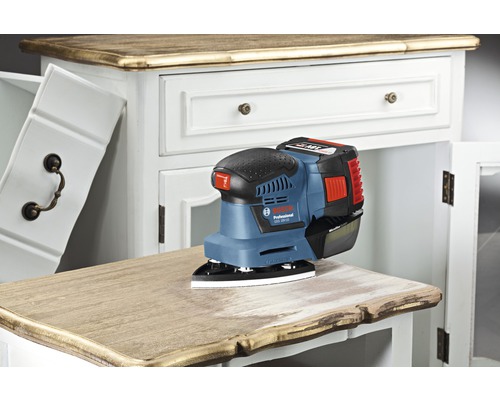 Accu-excentrische schuurmachine bij het schuren van een ladekast