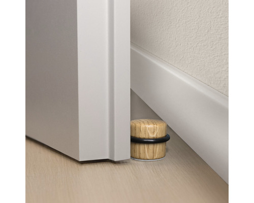 Houten deurstopper met rubberen ring naast een deur