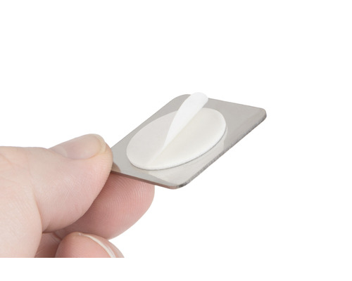 Metalen bord met zelfklevende pad in de hand