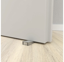 Deurstopper onder een deur op een houten vloer