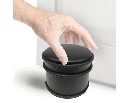 Zwarte rubberen deurstopper met hand bij de deur