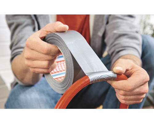 Persoon repareert een slang met ducttape