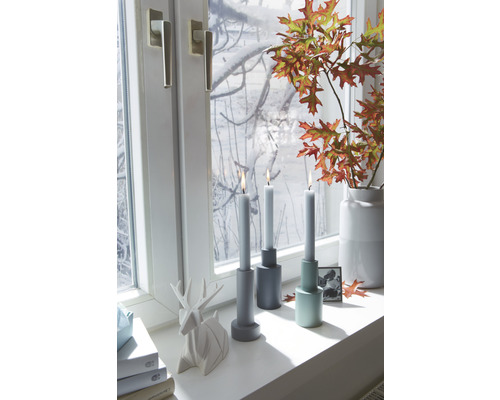 Decoratieve scène met kandelaars, kaarsen, raam, hertenbeeld en herfstbladeren