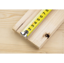 Geel rolmaat op een houten plank