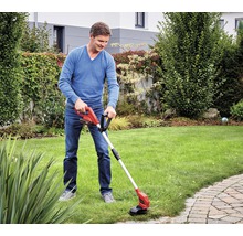 Man gebruikt een accugrasmaaier in de tuin.