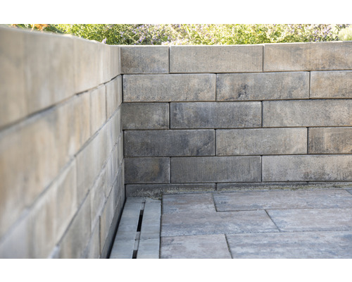 Muur en betonstraatstenen in de tuin