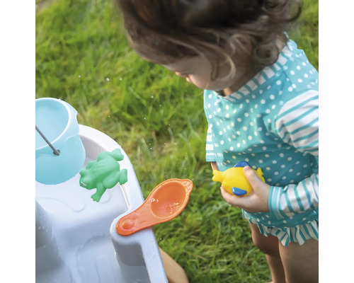 Kind speelt met een waterspeeltafel met emmer, kikker, schep en vis