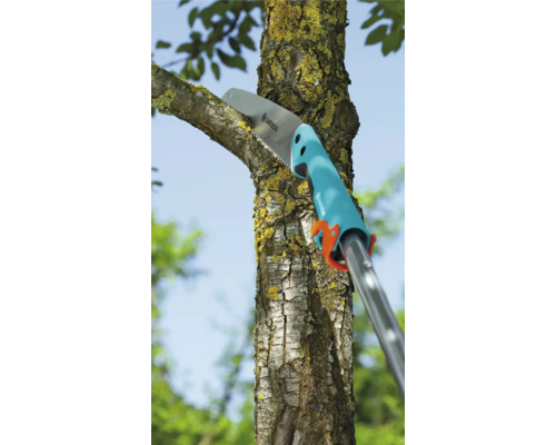 Een takkenzaag snijdt een tak aan een boom.