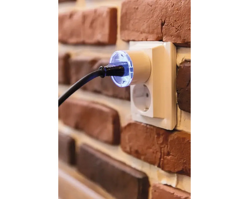 Stopcontact met stekker in een bakstenen muur