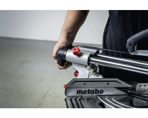 Hand van de bediener op een Metabo verstekzaag.