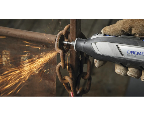 Een persoon gebruikt een Dremel 8240 multitool om een ketting door te snijden, waarbij vonken ontstaan.