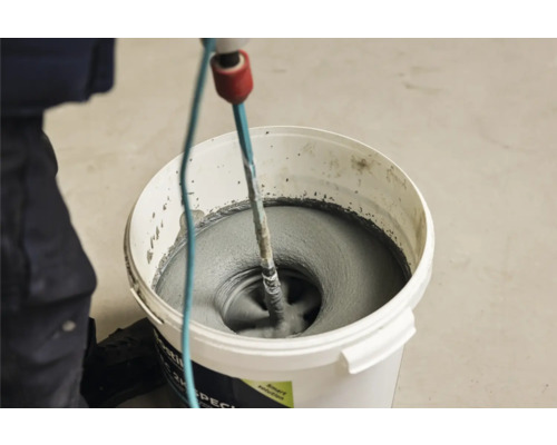 Mortel wordt in een emmer gemengd met een mixer.