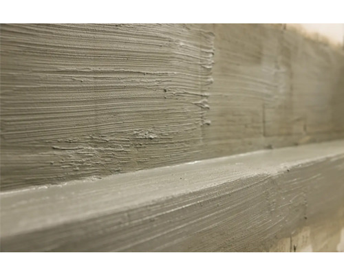 Close-up van een grof bepleisterde muur