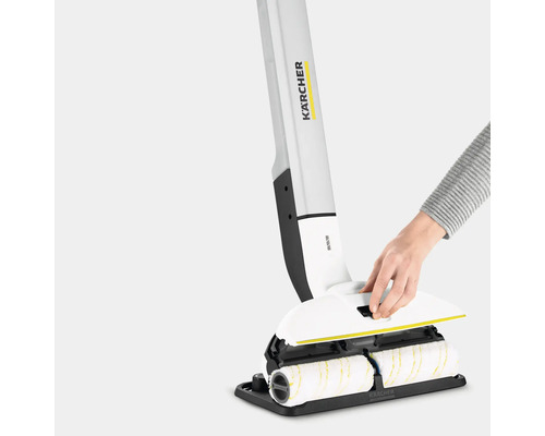 Kärcher harde vloerreiniger met roterende rollen en een hand die de klep optilt
