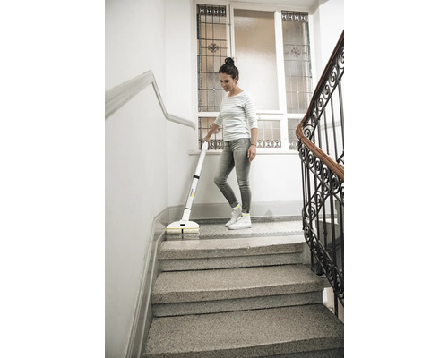 Vrouw reinigt trap met draadloze vloerreiniger