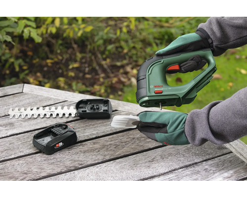 Accuschaar met accu, mes en accessoires op een houten tafel