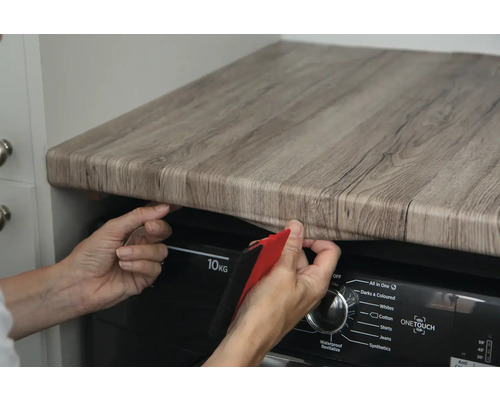 Decoratieve folie in houtlook wordt op een tafel bevestigd