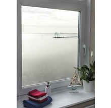 Uitzicht door een raam met melkglasfolie op de zee