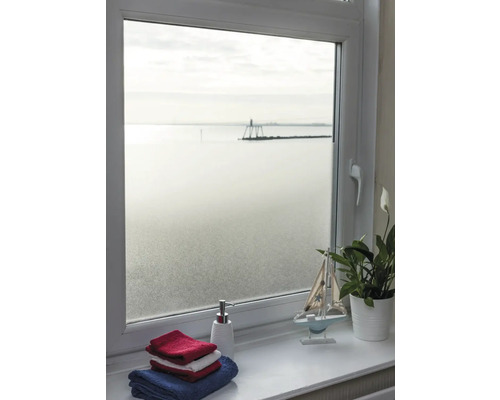 Uitzicht door een raam met melkglasfolie op de zee