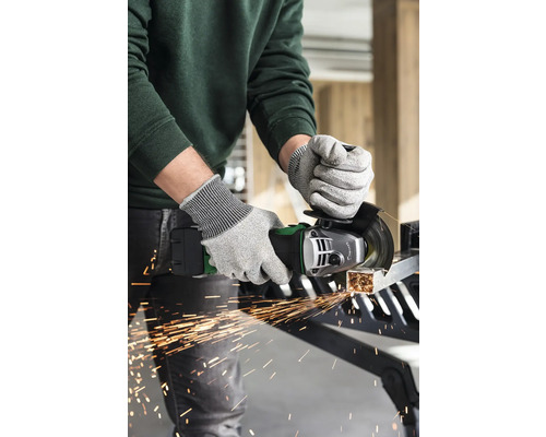 Een persoon gebruikt een haakse slijper met veiligheidshandschoenen om een stuk metaal te snijden, waarbij vonken vrijkomen.