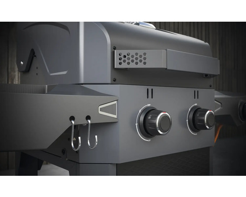 Detail van een gasbarbecue met draaiknoppen en haken