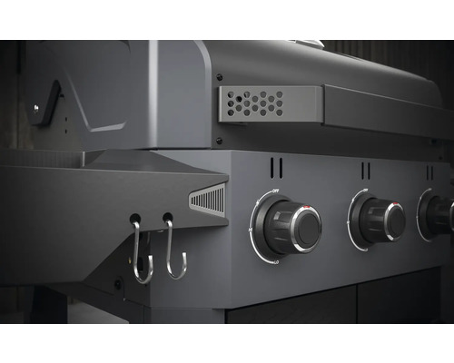 Detailopname van een gasbarbecue met bedieningsknoppen en haken