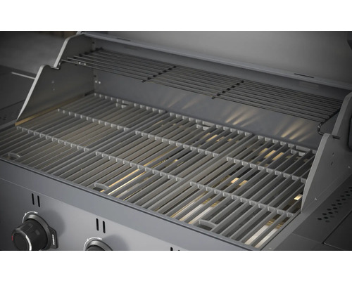 Binnenkant van een barbecue met grillrooster en warmhoudrek