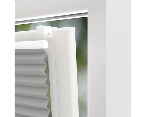 Detailaanzicht van een plisségordijn op een raam