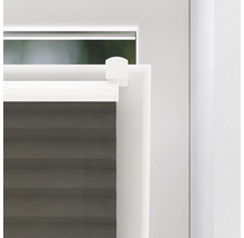 Detailopname van een grijs plisségordijn op een raam