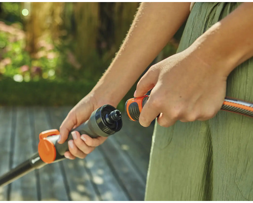 Persoon verbindt tuinslang met een verbindingsstuk.