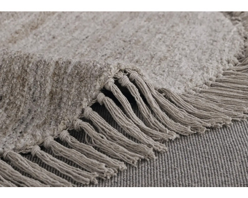 Detailopname van een rond vloerkleed met franjes