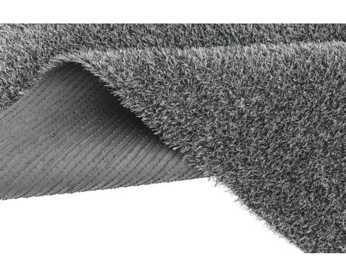 Grijs kunstgras met opgerolde hoek die de achterkant laat zien