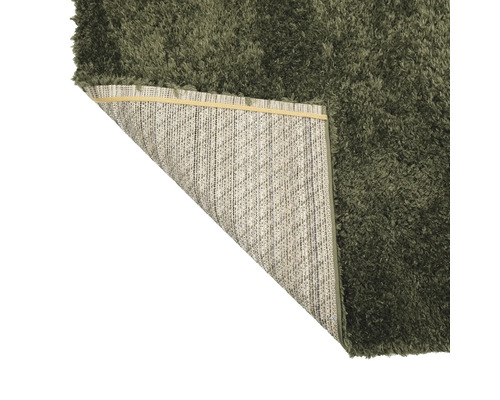 Hoogpolig tapijt met omgeslagen hoek, achterkant zichtbaar