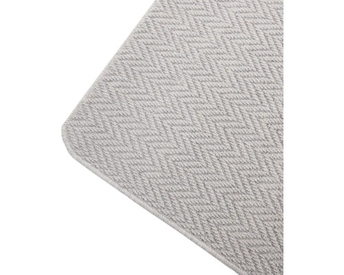 Detailweergave van een vloerkleed met visgraatmotief