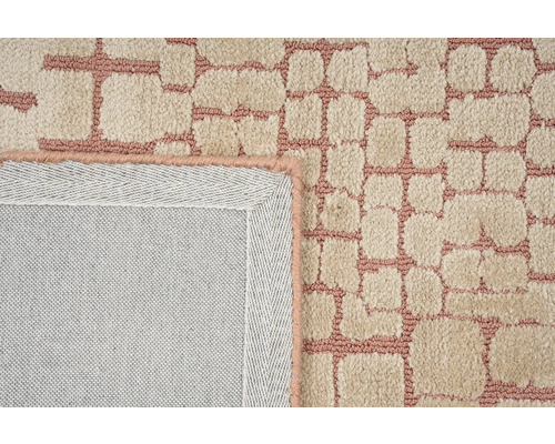 Gedetailleerd beeld van een beige tapijt met patroon