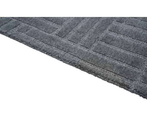 Detailweergave van een grijs tapijt met geometrisch patroon