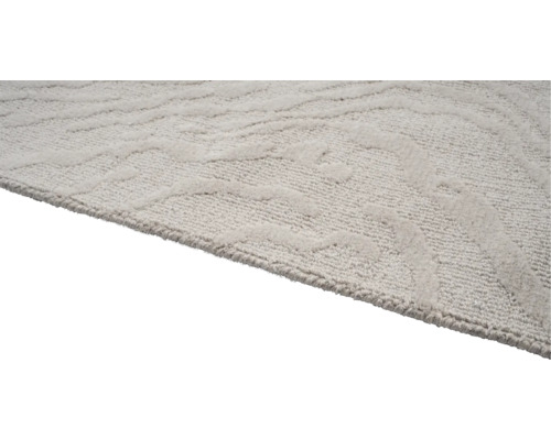 Detailweergave van een lichtgekleurd tapijt met patroon