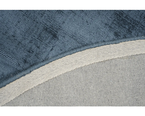 Detailopname van een blauw tapijt met textielpatroon