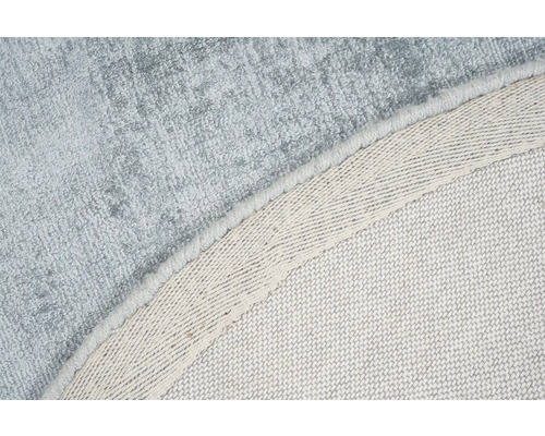 Detail van een rond vloerkleed met textiele rug